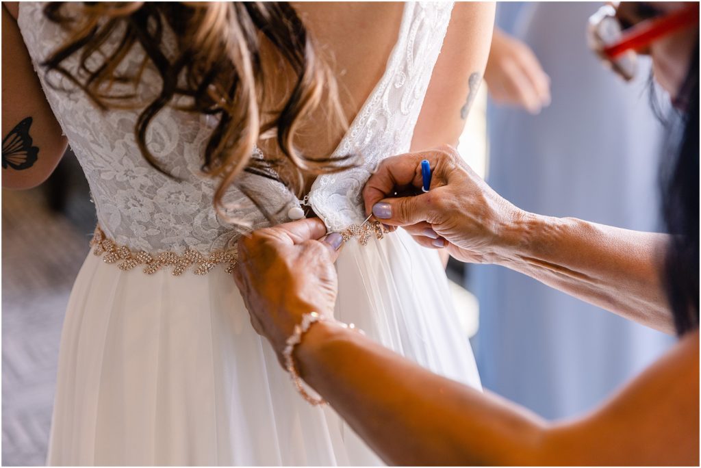 Bride getting dress on at Columbine Country Club