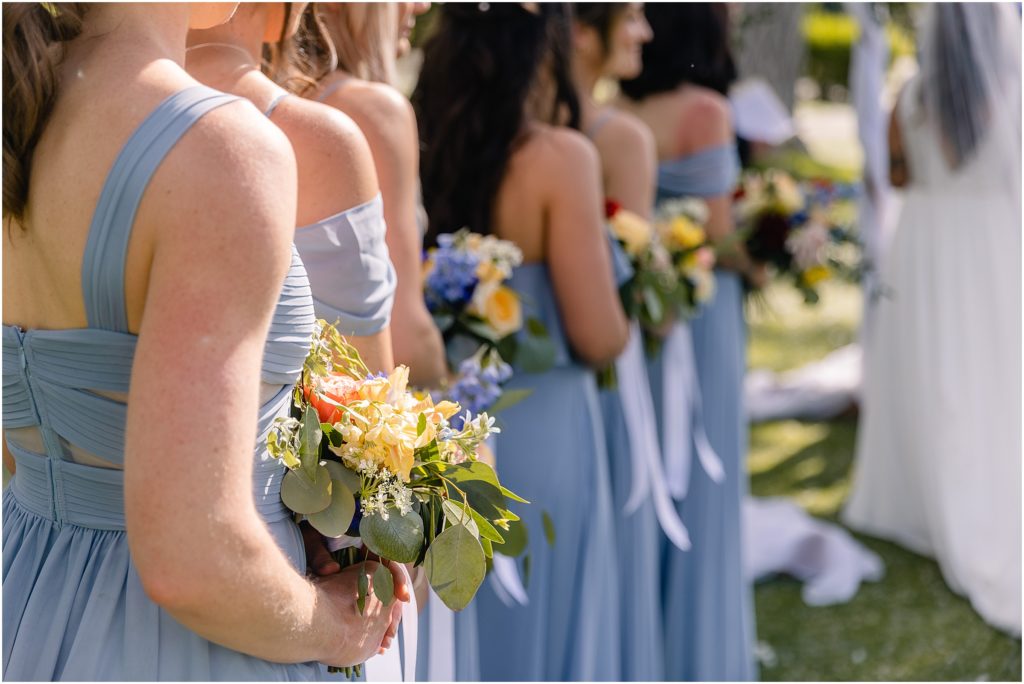 Bridesmaids holding flowers designed by Prive Events 