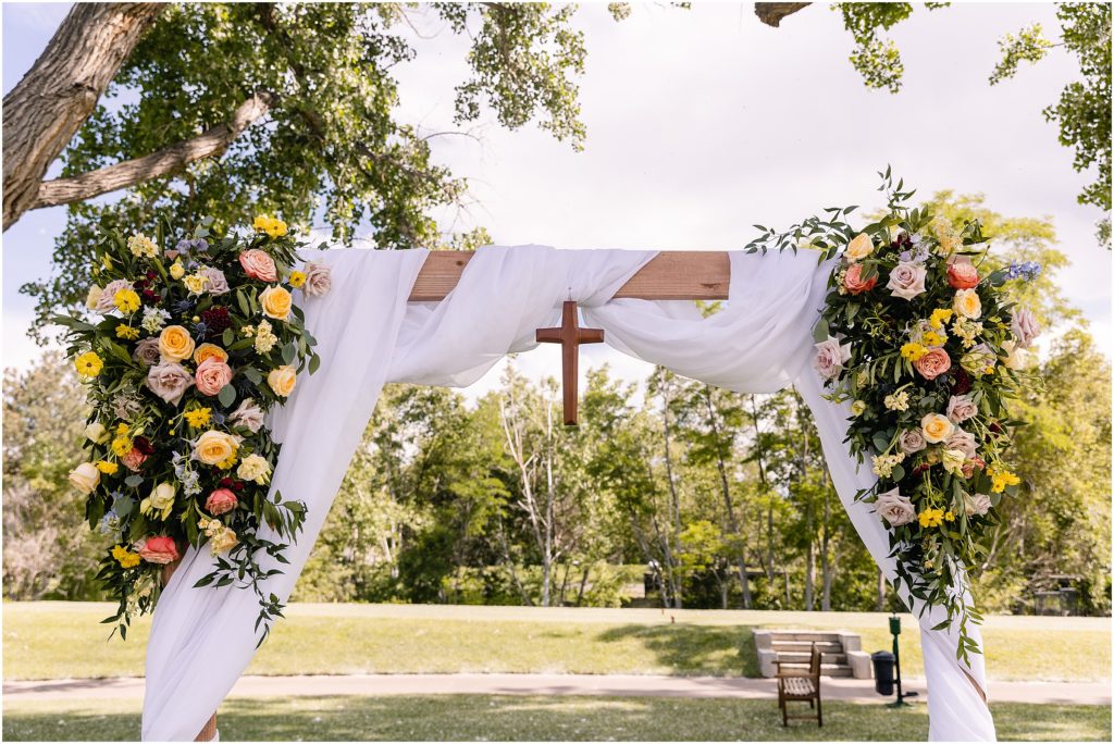 Wedding arch with floral design by Prive Events at Columbine Country Club