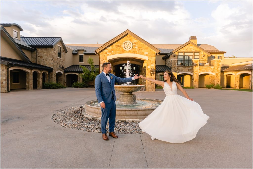 Bride and groom outside by fountain at Columbine Country Club