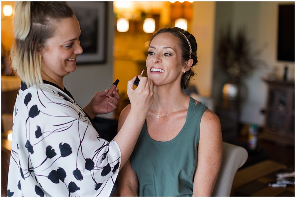 Bride getting makeup done by Alchemy Face Bar for wedding at Donovan Pavilion in Vail.