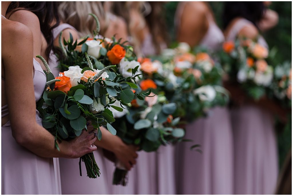 Bridal party with floral design by Veldkamps during wedding ceremony at Donovan Pavilion in Vail.