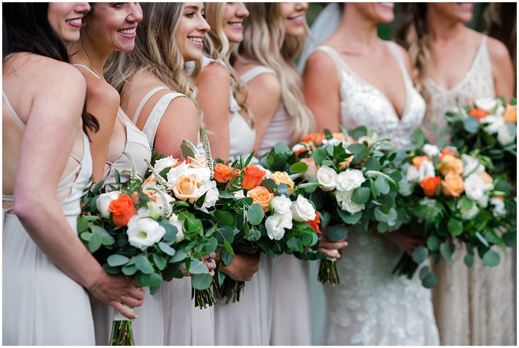 Bridal party with floral design by Veldkamps after wedding ceremony at Donovan Pavilion in Vail.