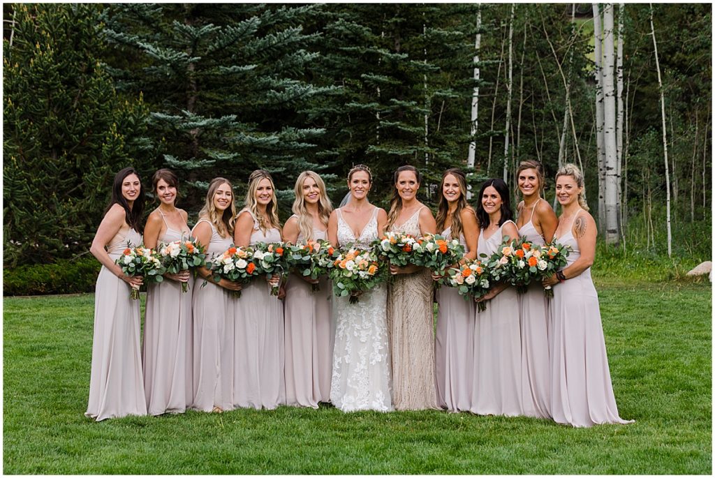Bridal party with floral design by Veldkamps after wedding ceremony at Donovan Pavilion in Vail.