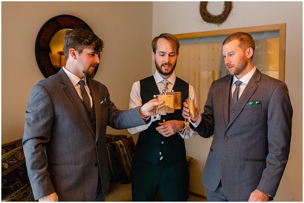 Groom and groomsmen holding flasks