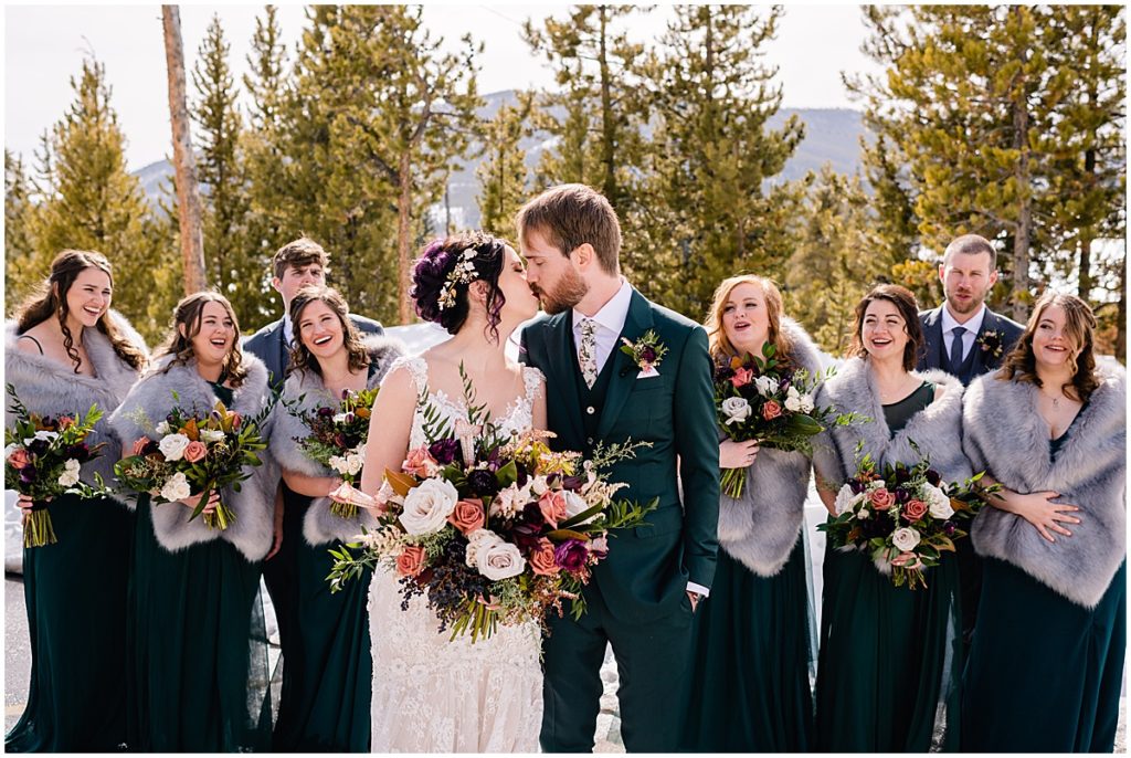 Bridal party outside at Keystone Ranch. Bridesmaids wearing dress from Birdy Grey.  Groomsmen wearing suits from The Black Tux.