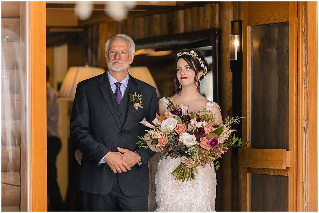Father walking bride down for wedding at Keystone Ranch