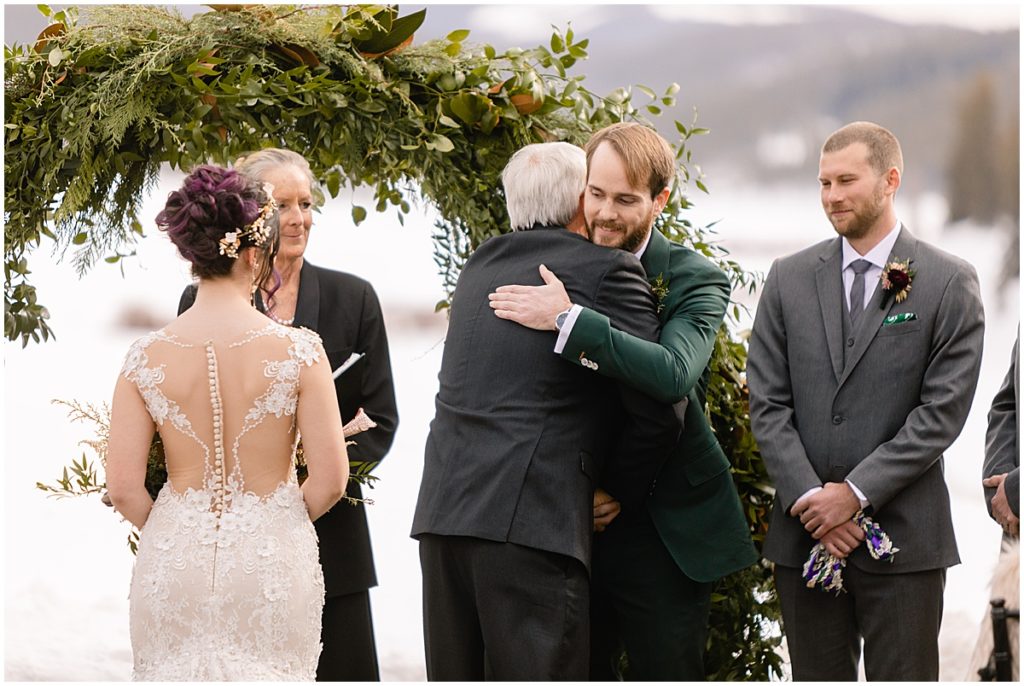 Groom hugging father of the bride at Keystone Ranch