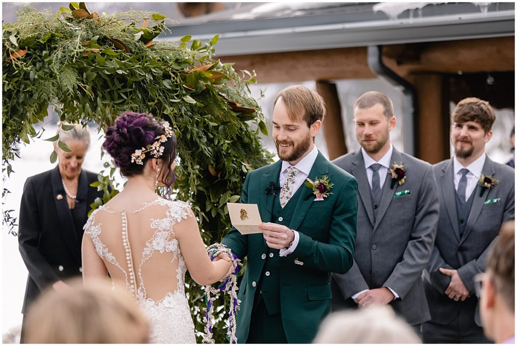 Groom reading vows to bride during ceremony at Keystone Ranch