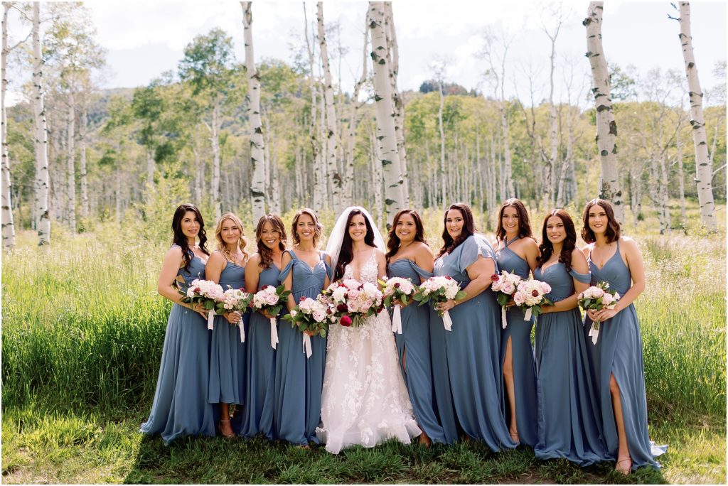 Bride with bridesmaid at Flying Diamond Ranch in Steamboat Springs. Bride holding bouquet designed by We Plus You.