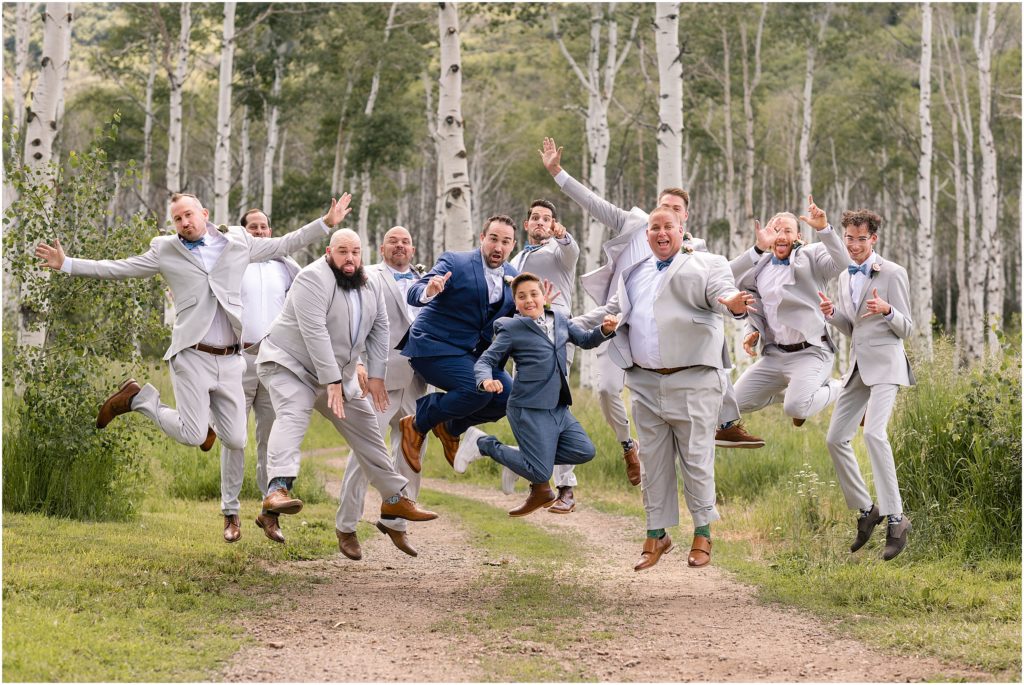 Groom with groomsmen jumping pose at Flying Diamond Ranch in Steamboat Springs. 