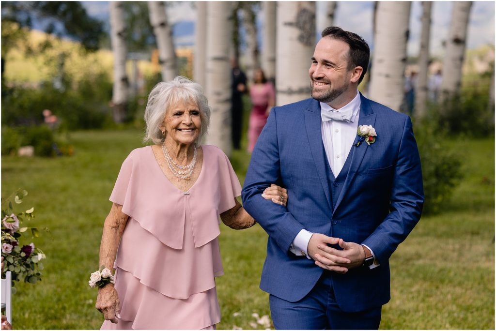 Groom with grandma walking down for ceremony at Flying Diamond Ranch in Steamboat Springs