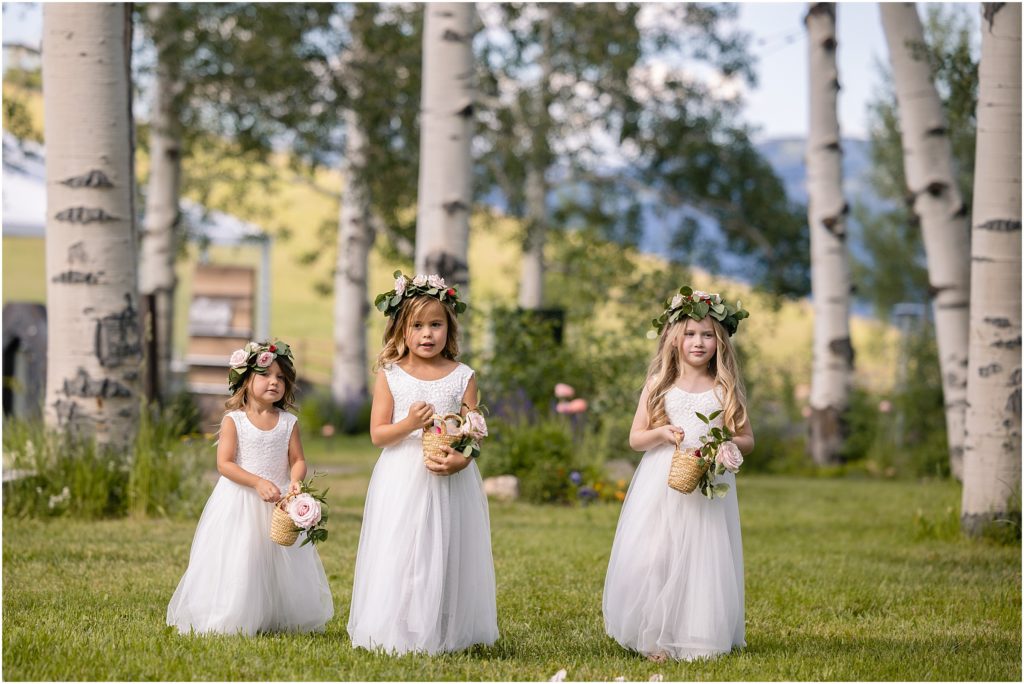 Flower girls walking down for ceremony at Flying Diamond Ranch in Steamboat Springs