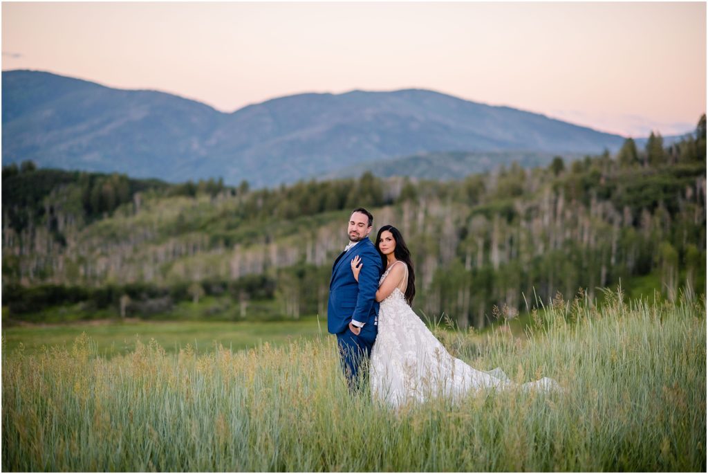 Bride and groom outside with mountain background after wedding ceremony at Flying Diamond Ranch in Steamboat Springs