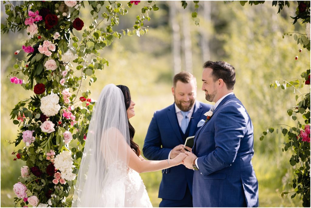 Groom and bride looking at each other during ceremony at Flying Diamond Ranch in Steamboat Springs
