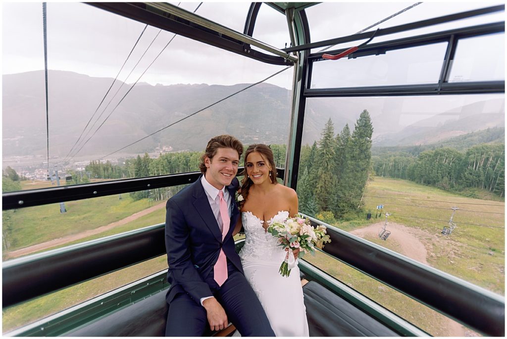 Bride and groom riding gondola in Vail