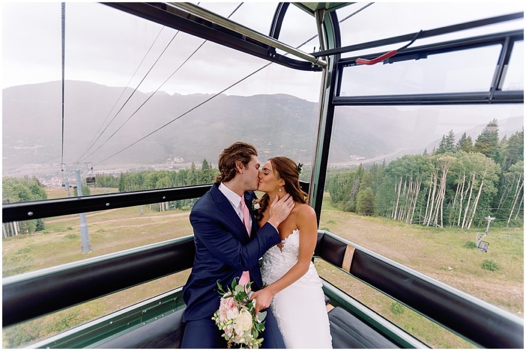 Bride and groom riding gondola in Vail