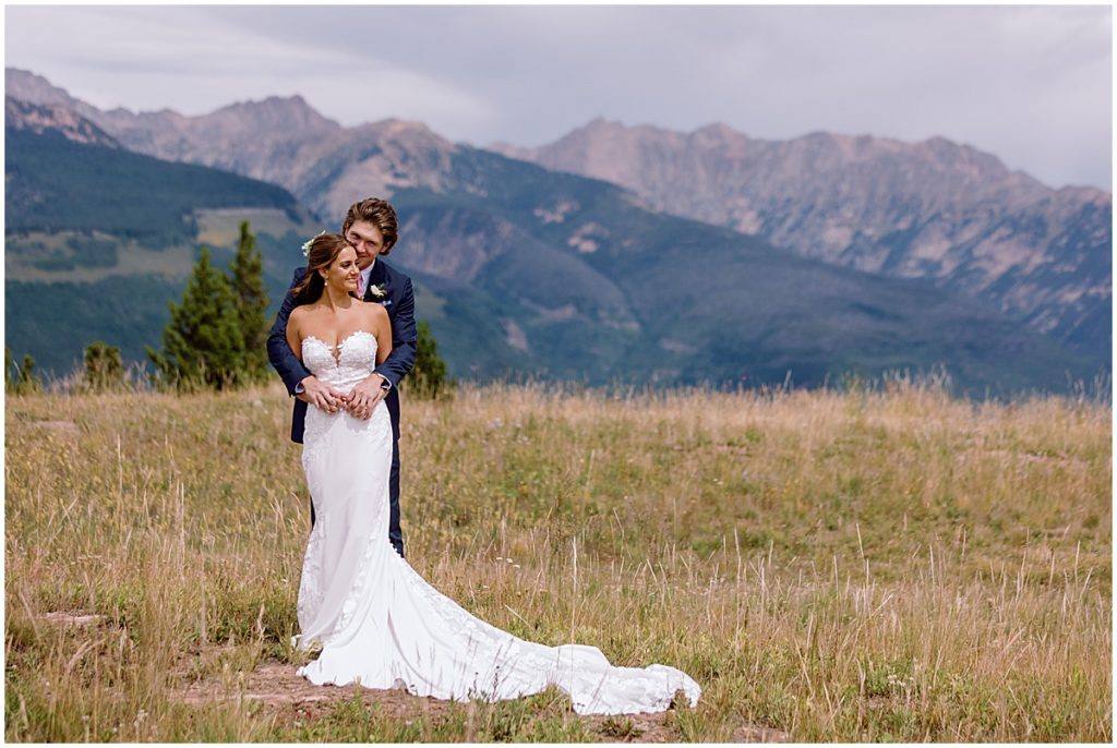 Bride and groom at top of Vail mountain. 