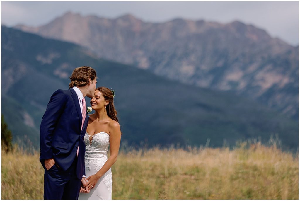 Bride and groom at top of Vail mountain. 