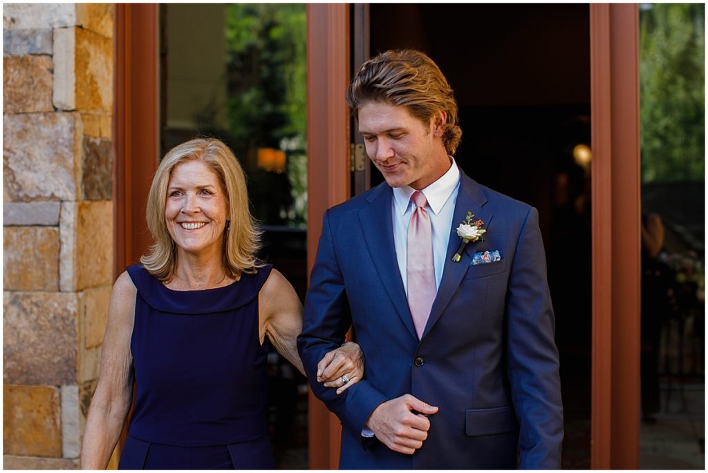 Groom walking down isle with mom at Four Seasons Vail.