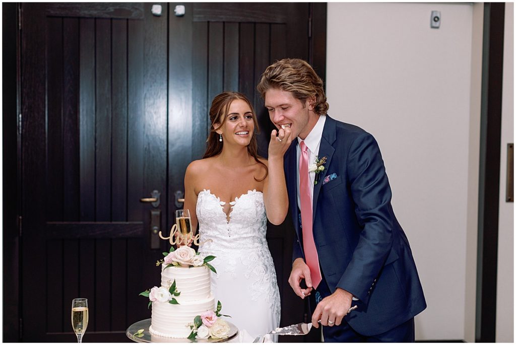 Bride and groom cutting cake designed by Cornerstone Chocolates & Confections.