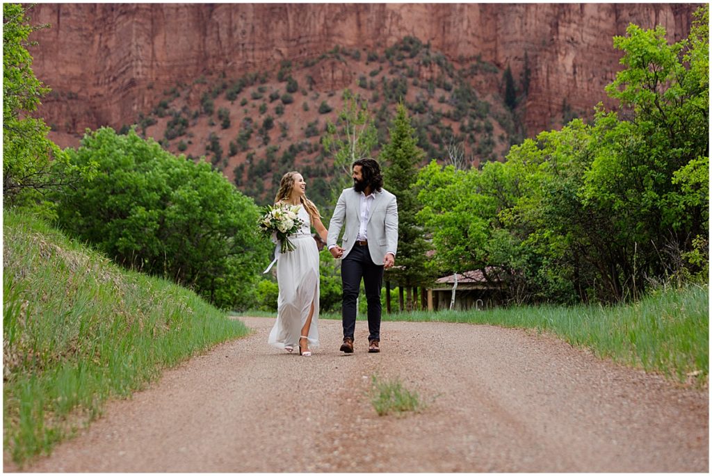 Bride and groom walking outside of 7 Castles Ranch after wedding ceremony