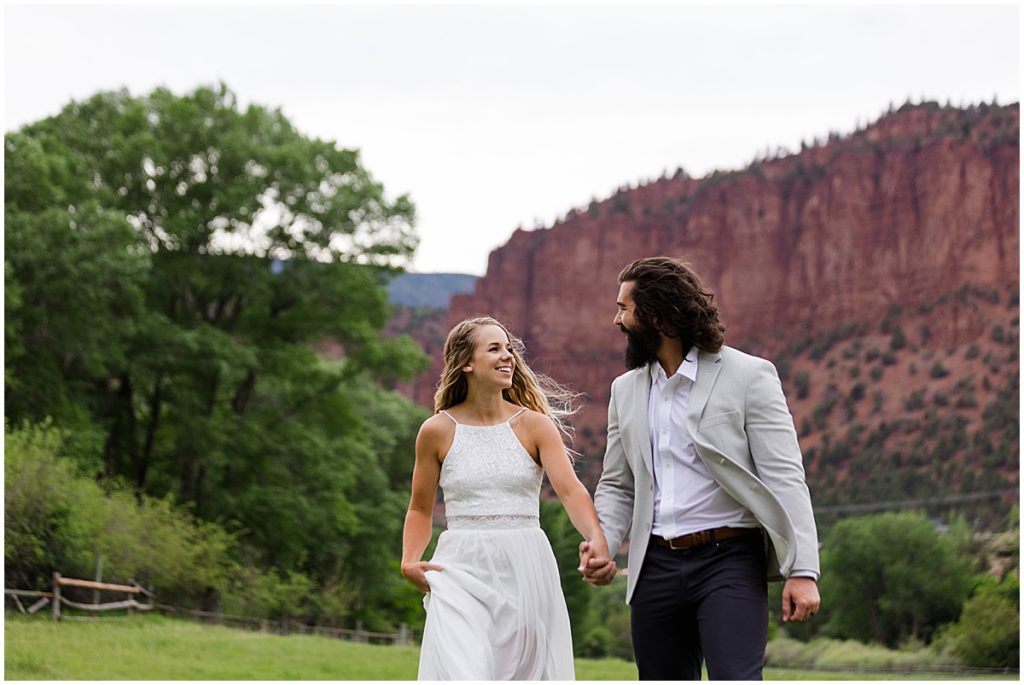 Bride and groom walking outside of 7 Castles Ranch after wedding ceremony