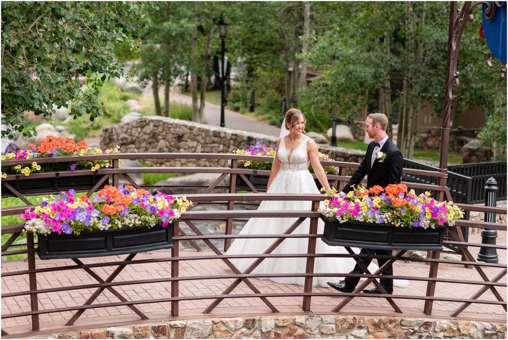 Bride and groom walking outside on bridge at Park Hyatt Beaver Creek
