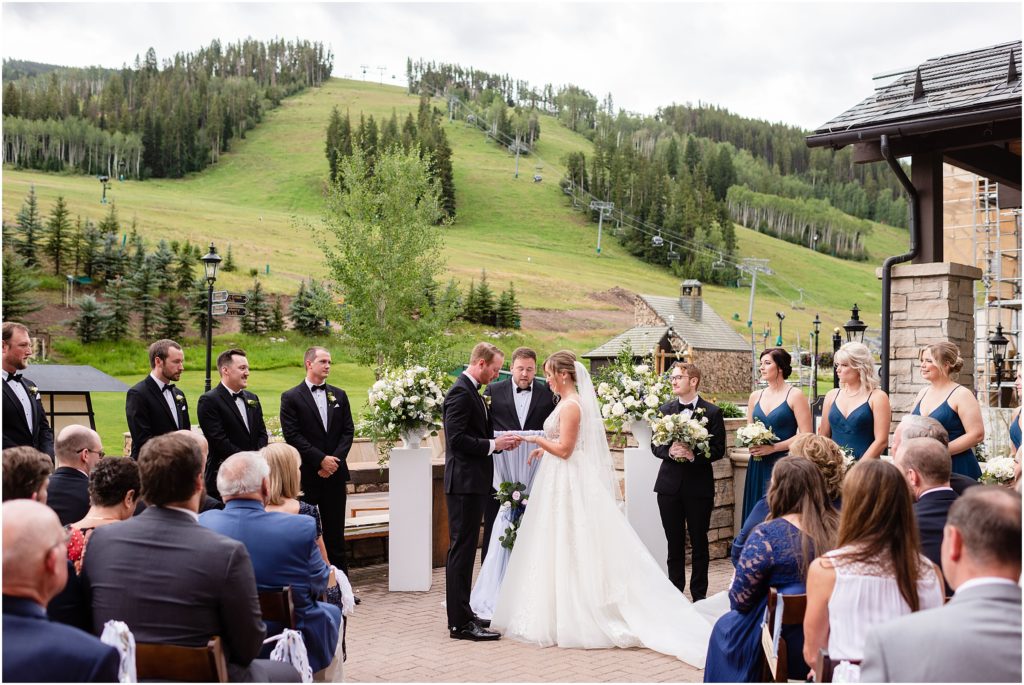 Bride and groom exchanging rings during wedding ceremony in Beaver Creek Park Hyatt