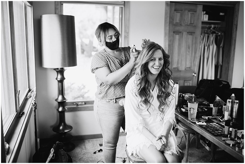 Bride getting hair and makeup done by Alchemy Creative for wedding at the Stanley Hotel in Estes Park