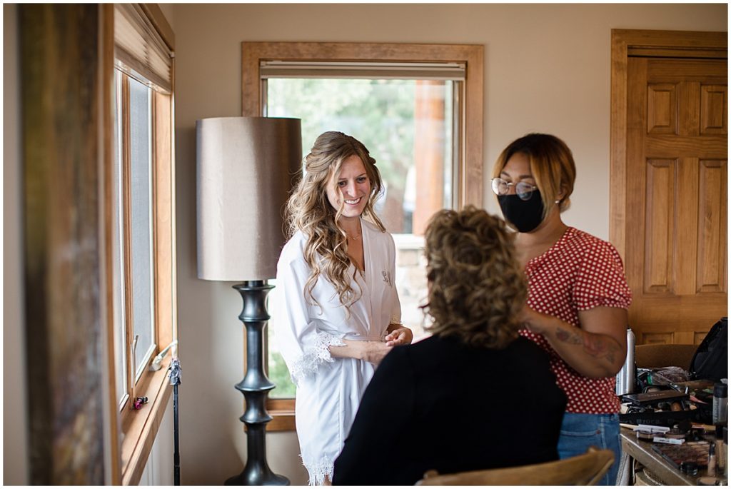 Bride getting hair and makeup done by Alchemy Creative for wedding at the Stanley Hotel in Estes Park