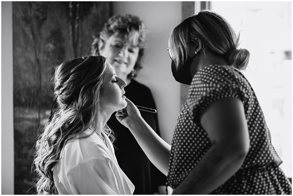 Bride getting hair and makeup done by Alchemy Creative for wedding at the Stanley Hotel in Estes Park