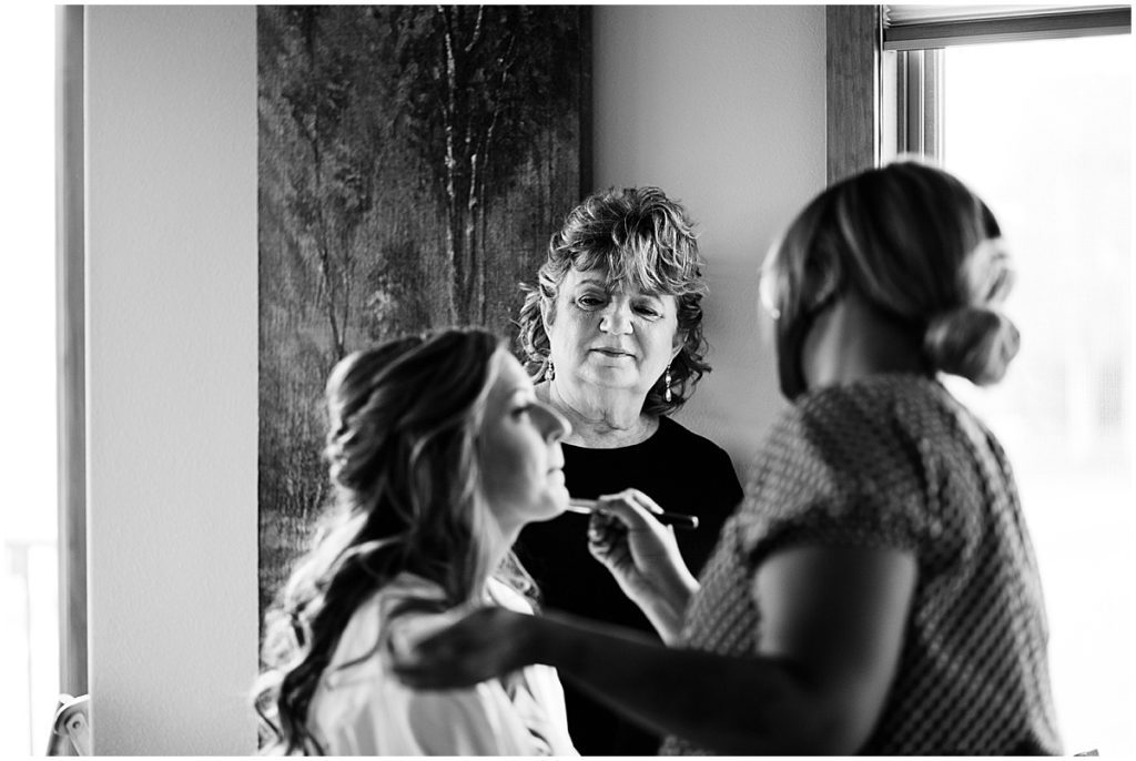 Bride getting hair and makeup done by Alchemy Creative for wedding at the Stanley Hotel in Estes Park