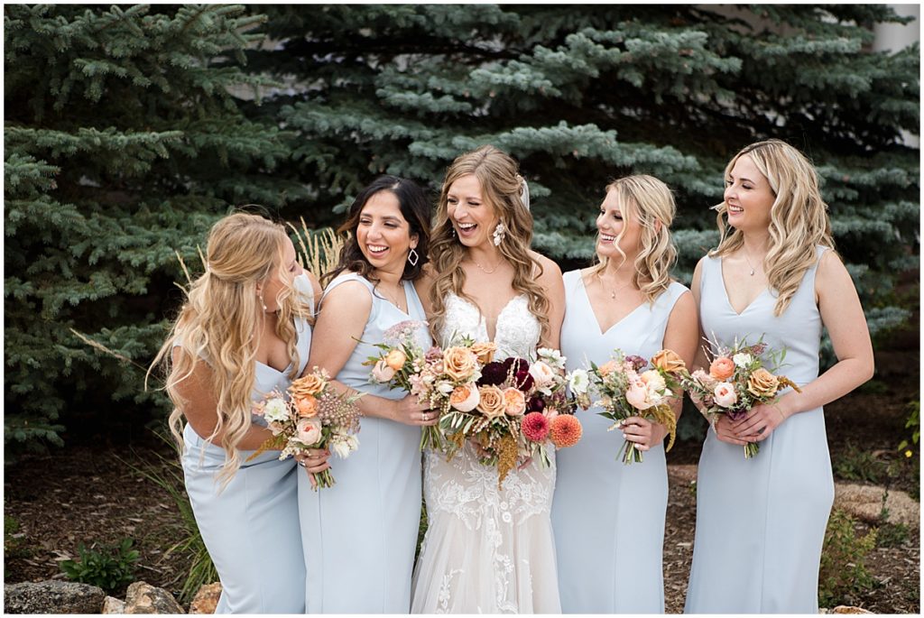 Bride wearing wedding dress from Town and Country Bridal and bridesmaids wearing dress from Amsale.  Floral decor by Lace and Lilies Flowers.