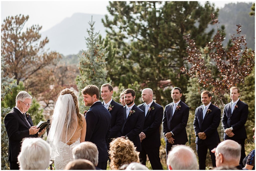 Wedding ceremony at the Stanley Hotel in Estes Park.  Groom and groomsmen wearing suits from Jos A Bank.