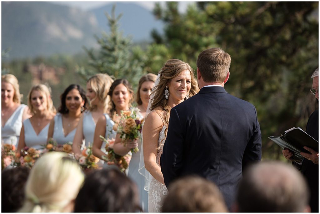 Bride and groom during wedding ceremony at the Stanley Hotel in Estes Park.  Bridesmaids wearing dress from Amsale.