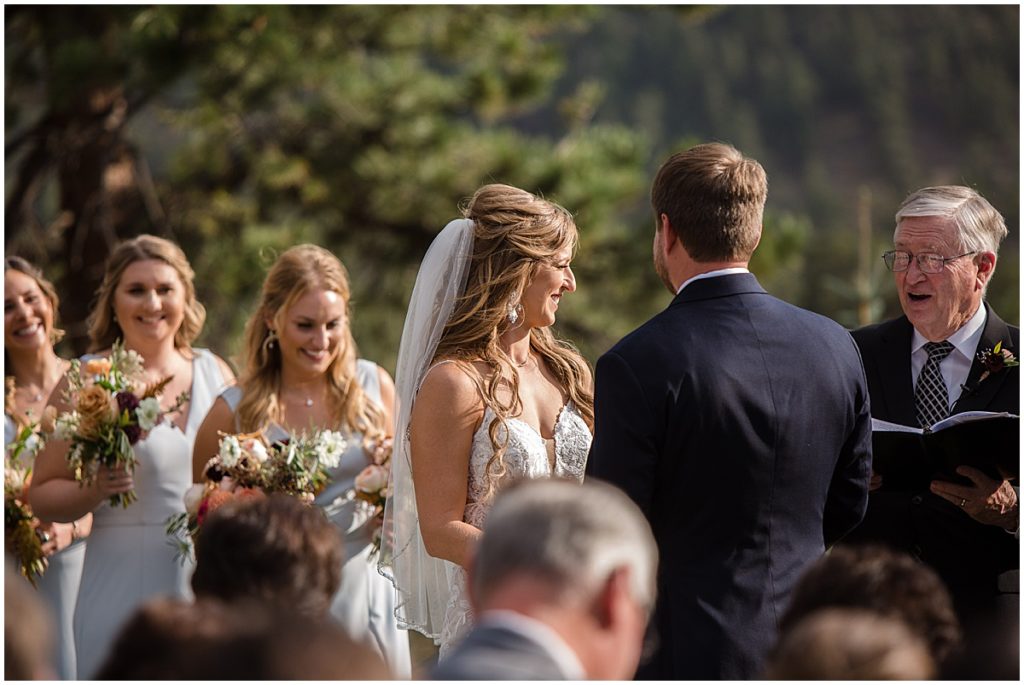 Bride and groom during wedding ceremony at the Stanley Hotel in Estes Park.  Bridesmaids wearing dress from Amsale.