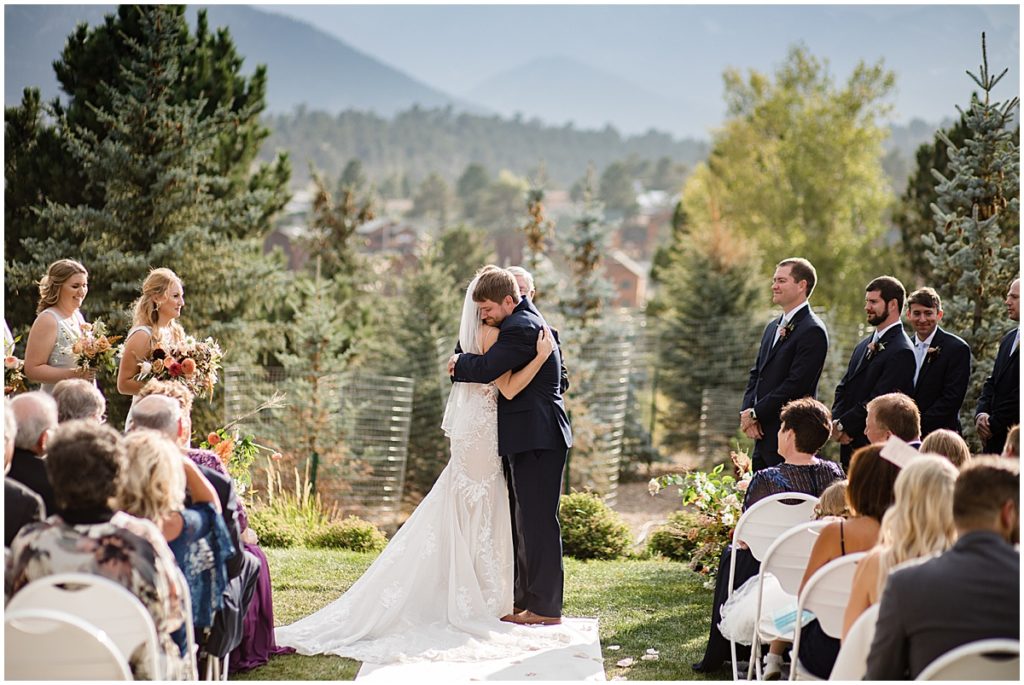 Bride and groom hugging during wedding ceremony at the Stanley Hotel in Estes Park.