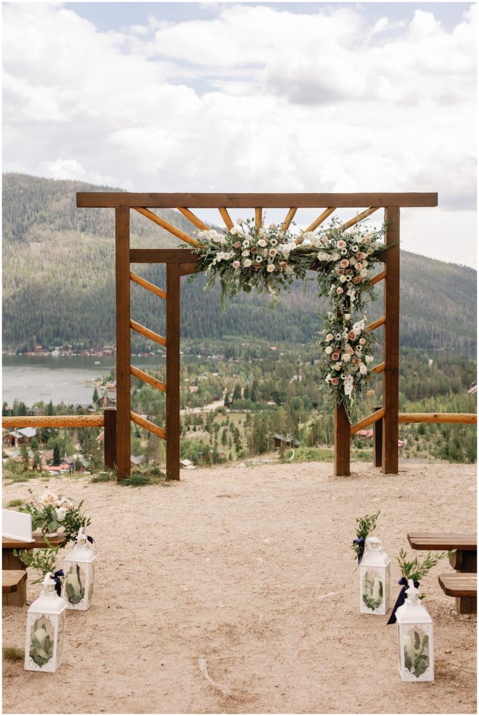 Wedding arch facing Grand Lake with floral decor by Palmer Flowers