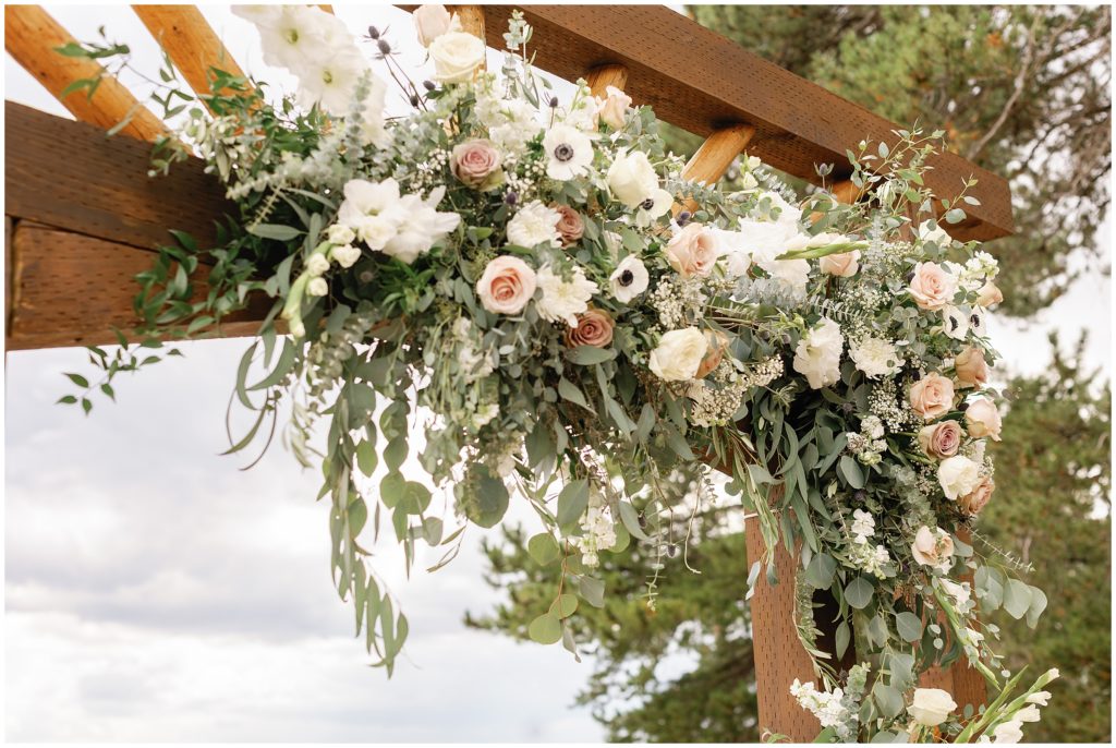 Wedding arch with floral decor by Palmer Flowers