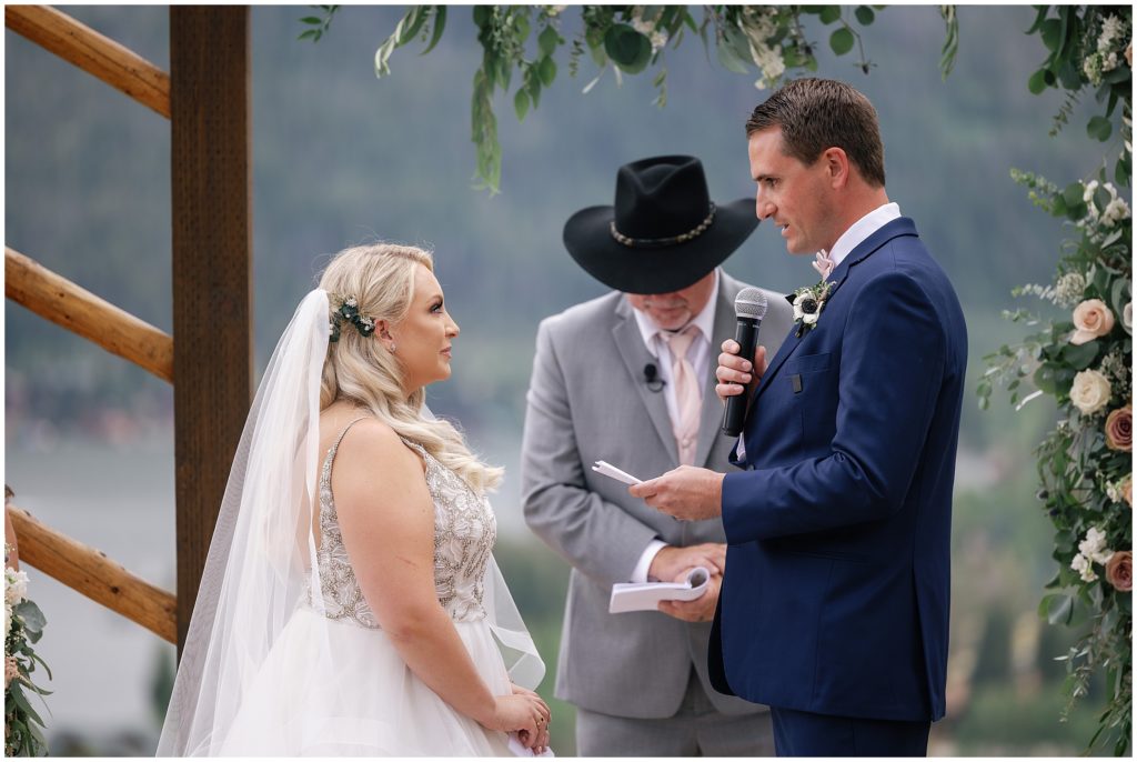 Groom reading vows to bride during ceremony at Grand Lake Lodge