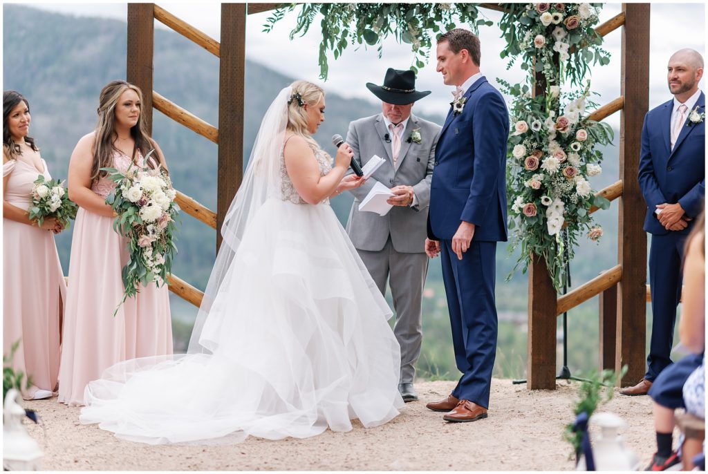 Bride reading vows to bride during ceremony at Grand Lake Lodge