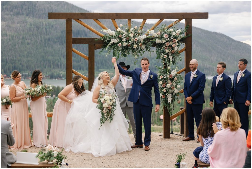 Bride and groom raising hands up after ceremony Wedding Ceremony at Grand Lake Lodge