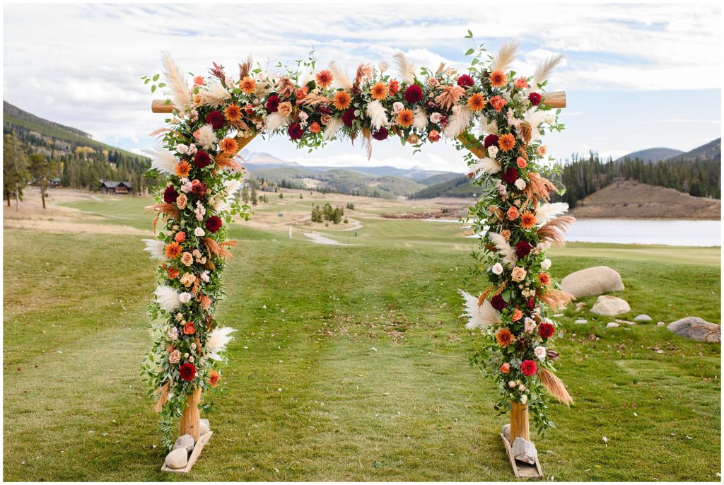 Outdoor ceremony site at Keystone Ranch with floral arch by Petal and Bean