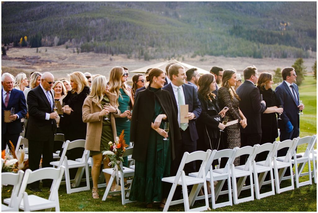 Guests standing for bride at Outdoor ceremony site at Keystone Ranch