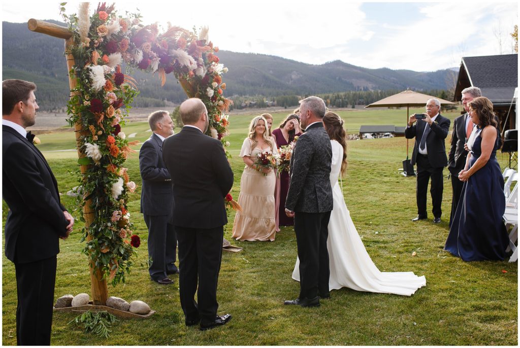 Bride with parents during ceremony at Keystone Ranch