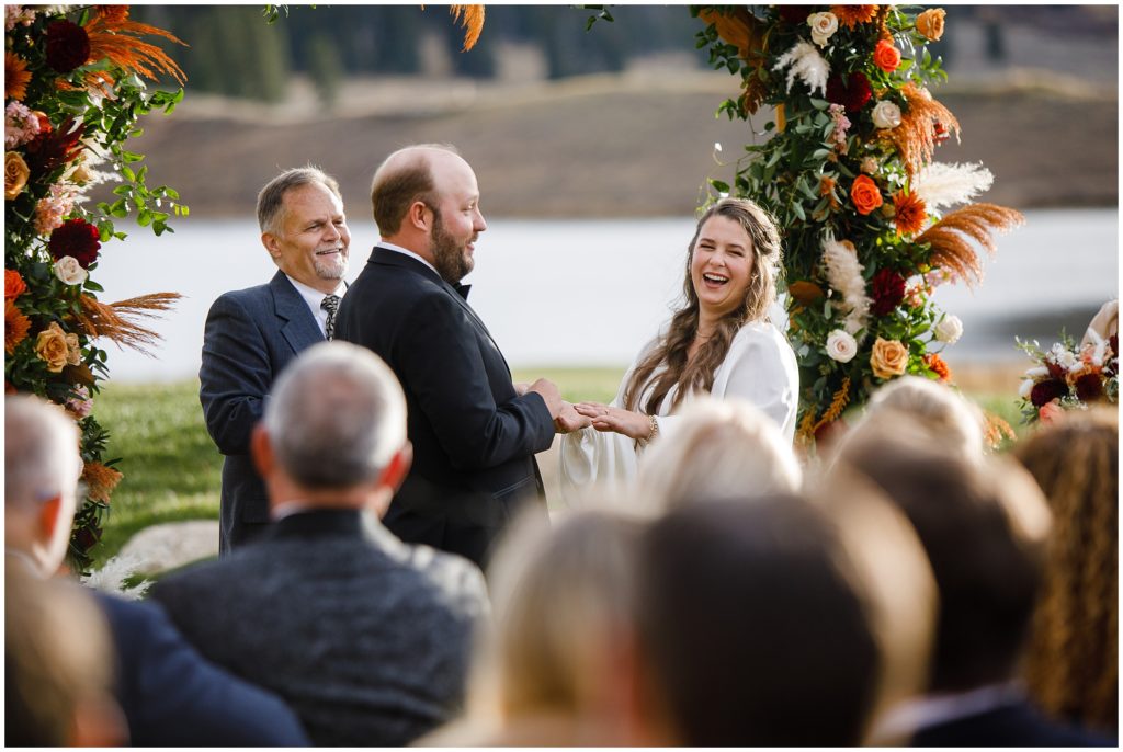 Bride laughing during wedding ceremony at Keystone Ranch
