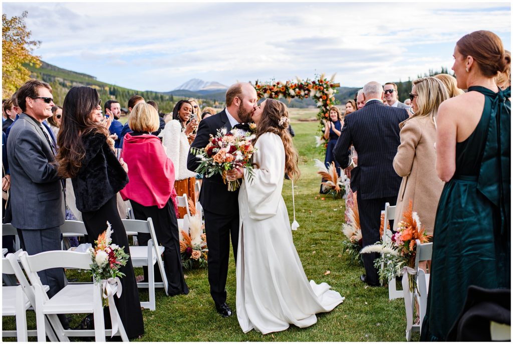 Bride and groom kiss after wedding ceremony at Keystone Ranch