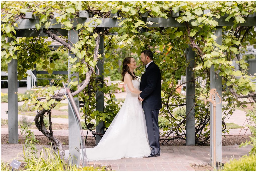 Groom and Bride at Denver Botanic Gardens wearing dress from Little White Dress.