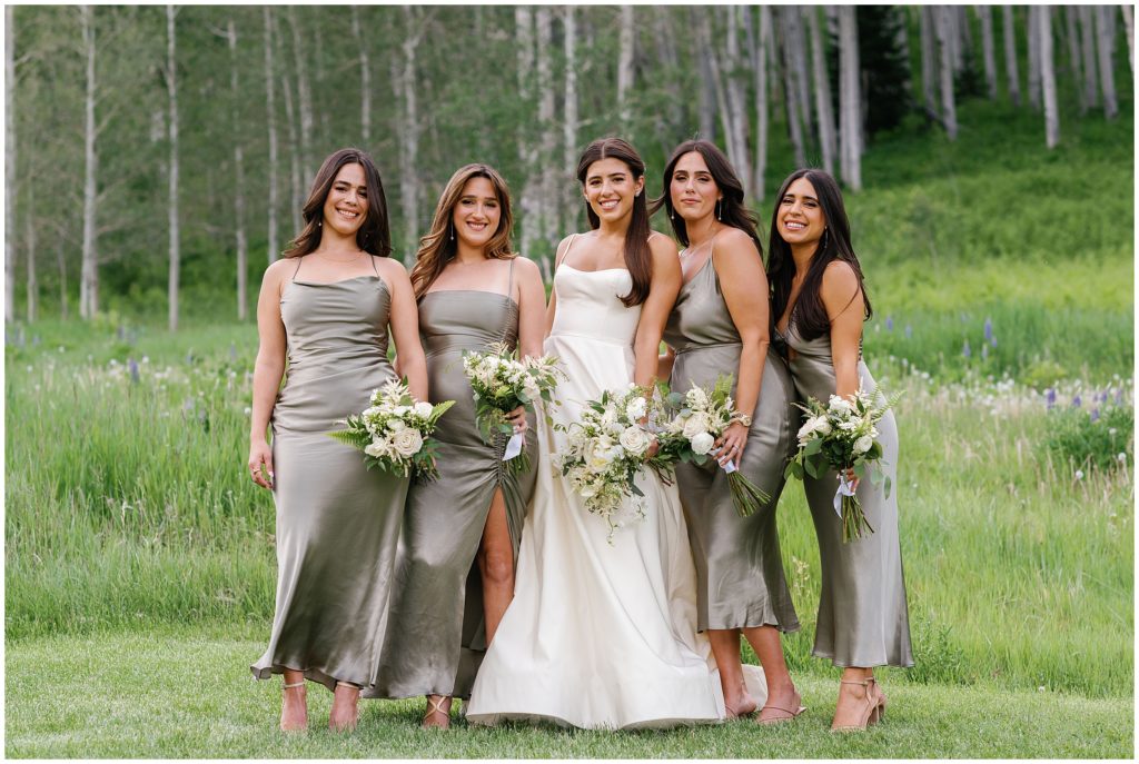 Bride with bridesmaids at Beaver Creek holding bouquets designed by Rose Petals Vail